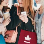 Friends shopping together and using smart phone