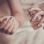 bride applying perfume on her wrist